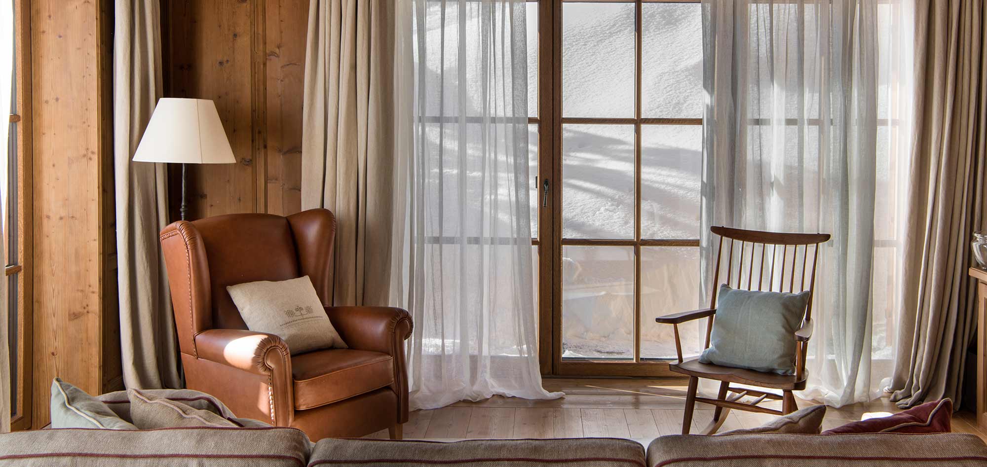 leather armchair wooden rocking chair snow chalet living room