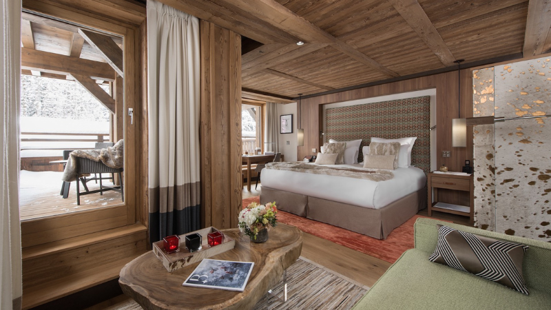 Wooden clad hotel room with terrace view and super kingsized bed