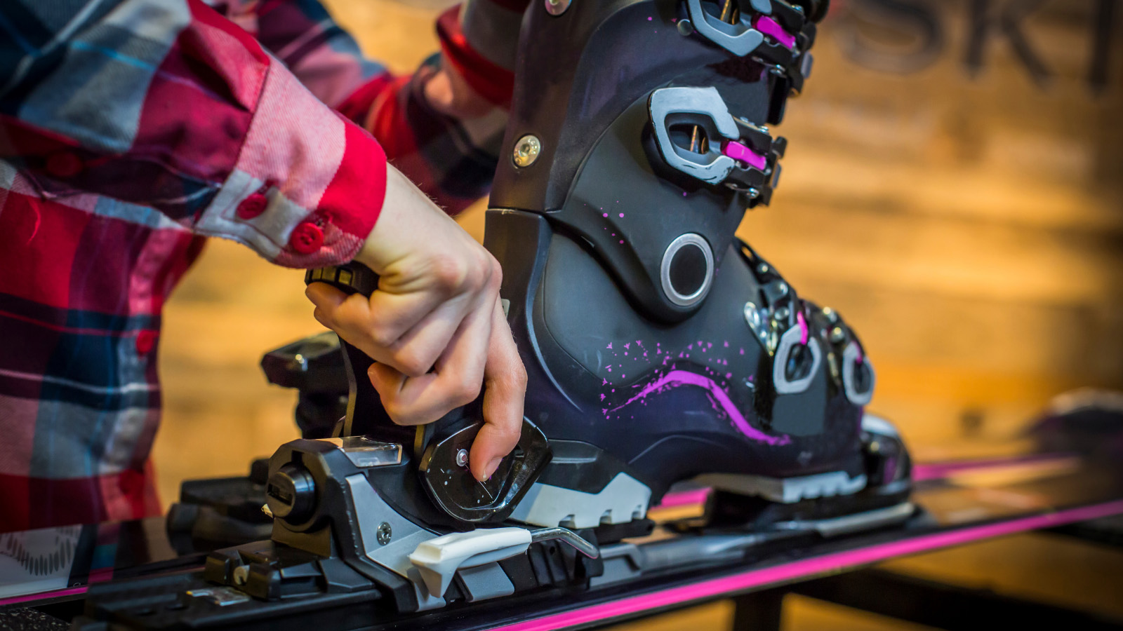 Man adjusting ski and ski boots