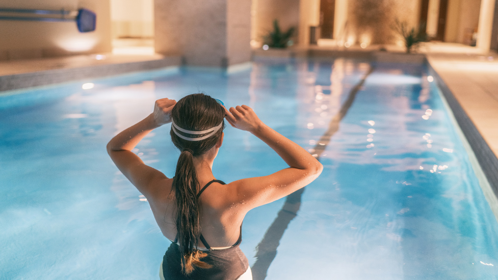 Lady getting ready to swim in pool