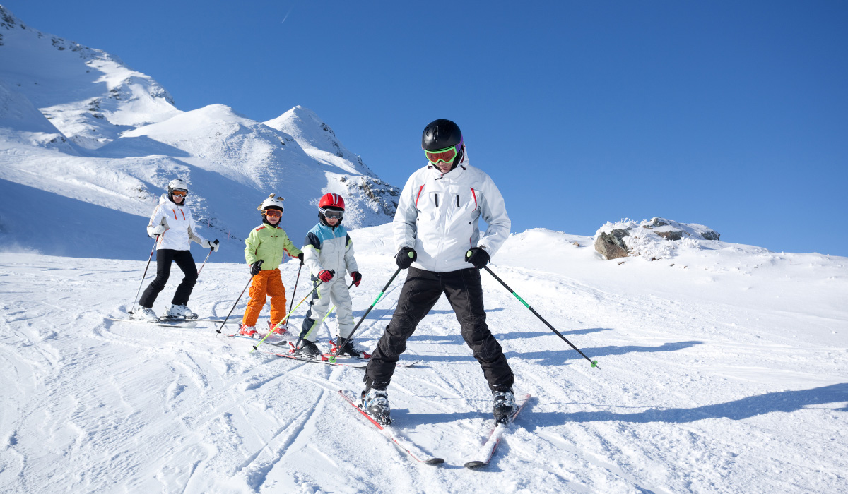 Family skiing down mountain