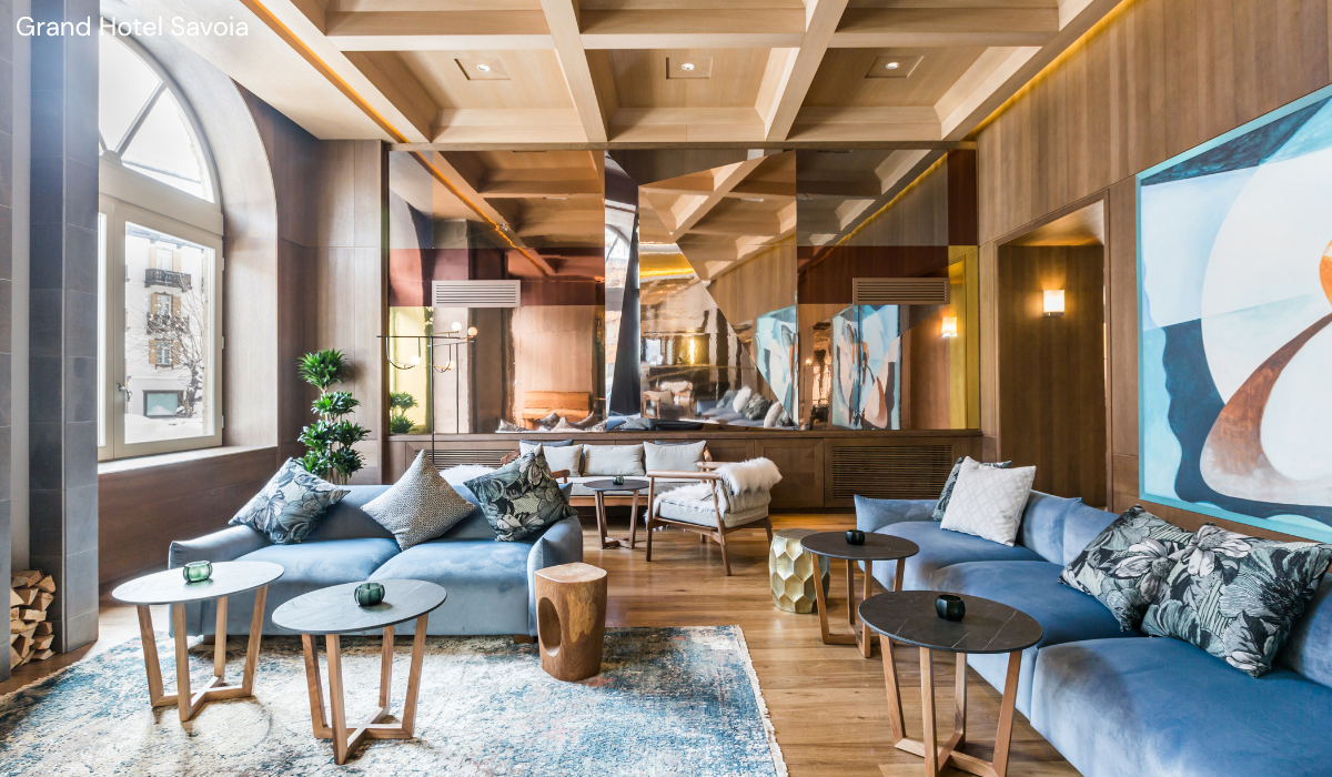 Blue hued soft furnishing and artwork adorn this woodclad seating area in hotel foyer.