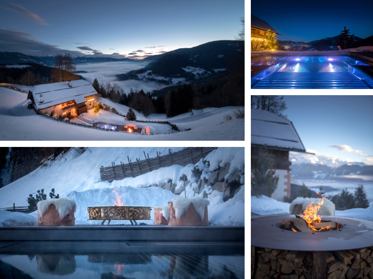 very snowy landscape witha lodge glowing in amber outdoor fairy lighting.